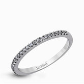 This eye-catching contemporary white gold engagement ring and wedding band set features an impressive halo accented by .63 ctw round cut white diamonds.
