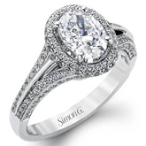 This lovely 18k white gold engagement ring design is created for an elegant oval center stone and features .77 ctw of white diamonds accented by a small touch of .03 ctw of yellow diamonds.
