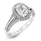 This lovely 18k white gold engagement ring design is created for an elegant oval center stone and features .77 ctw of white diamonds accented by a small touch of .03 ctw of yellow diamonds.