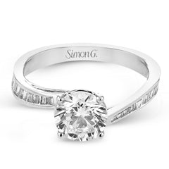 This engagement ring in 18 kt white gold has a gentle curved band of sparkling baguettes 0.39 ctw.