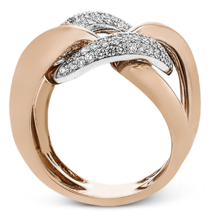 A modern take on the love knot this right hand ring in 18K yellow and white gold, features interlocking links of high polish gold and a diamond link 0.79 ctw.