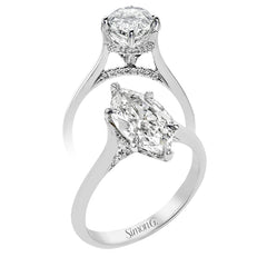 This elegant white gold engagement ring takes an marquise center and is adorned with a delicate under halo, and a line of diamonds on the side profile 0.13 ctw