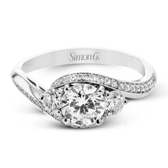 This beautiful ring features a three stone design with 2 side stones 0.33 ctw., set in a vintage-inspired shank. A diamond accented knife edge curved band .15ctw, and is perfect for those who want a classic look with a unique twist.