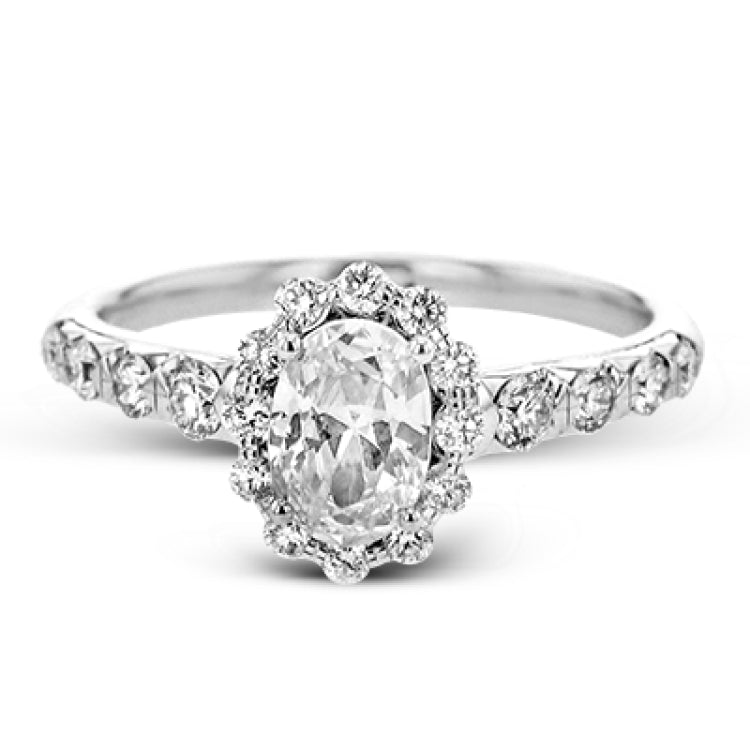 This 18K white gold antique design features a scalloped diamond halo which gives the ring a floral effect, and flush set side diamonds 0.48ctw, made for an oval center stone