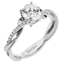 18K two-tone engagement ring has a delicate twist design with a polished yellow gold side trimmed with milgrain beading, and a diamond side 1/10 ctw. set in white gold