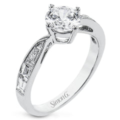 A fresh take on the engagement ring, this delicate ring has a high polished white gold shank with brilliant tapered baguettes .60 ctw, set in a soft milgrain beaded channel.