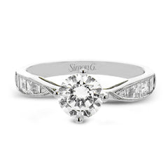 A fresh take on the engagement ring, this delicate ring has a high polished white gold shank with brilliant tapered baguettes .60 ctw, set in a soft milgrain beaded channel.