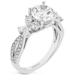 A beautiful engagement ring perfect for those who love floral inspired designs. It features a split shank setting with diamond accents .20ctw., & 8 pear shaped diamonds .62ctw. that create the look of petals around the center stone.