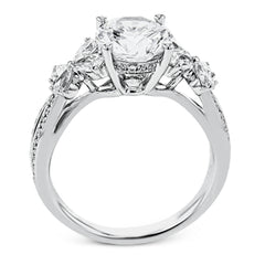 A beautiful engagement ring perfect for those who love floral inspired designs. It features a split shank setting with diamond accents .20ctw., & 8 pear shaped diamonds .62ctw. that create the look of petals around the center stone.