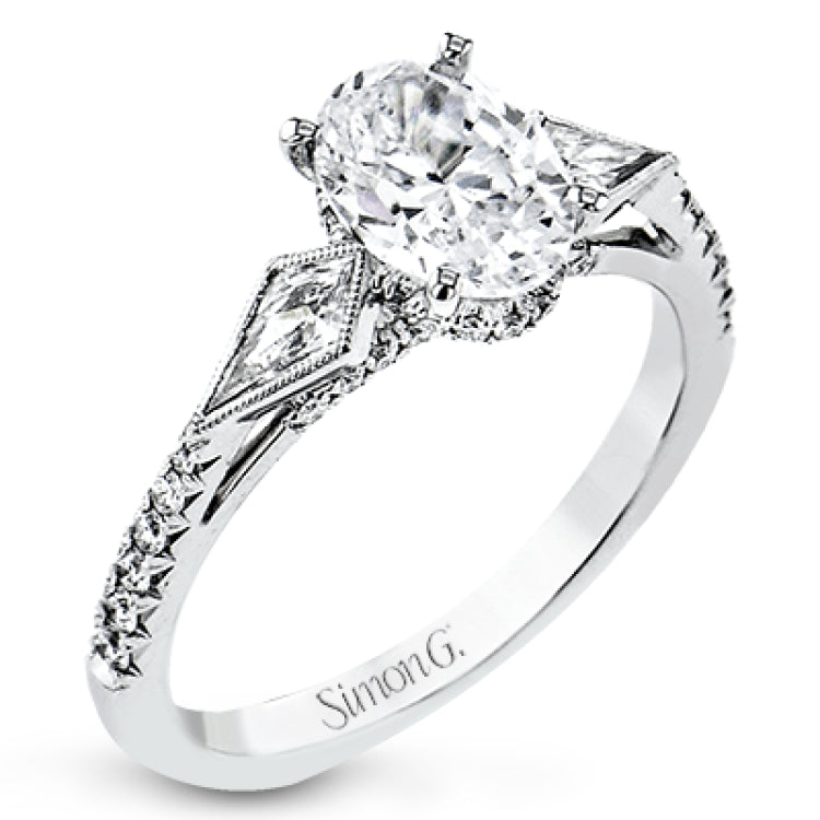 This modern 3 stone engagement ring is made for an oval center and flanked by 2 kite set diamonds 0.23 ctw, with round prong set diamonds along the shank 0.22 ctw.