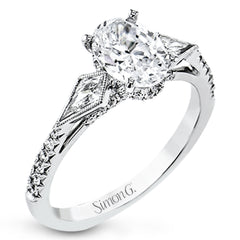 This modern 3 stone engagement ring is made for an oval center and flanked by 2 kite set diamonds 0.23 ctw, with round prong set diamonds along the shank 0.22 ctw.