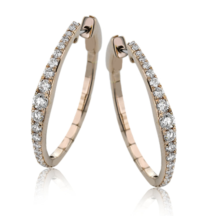 Dress up your classic button down with these 18K white gold hoops featuring .97cttw diamonds.