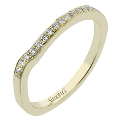 Contemporary 18 kt two-tone engagement ring has a swirl of white diamonds .24 ctw, set in yellow gold on a polished white gold shank