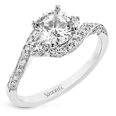 Contemporary 18 kt white gold engagement ring has a subtle knife edge and 2 diamonds of .21 ctw flanking the center, accented with a swirl of round diamonds .27 ctw