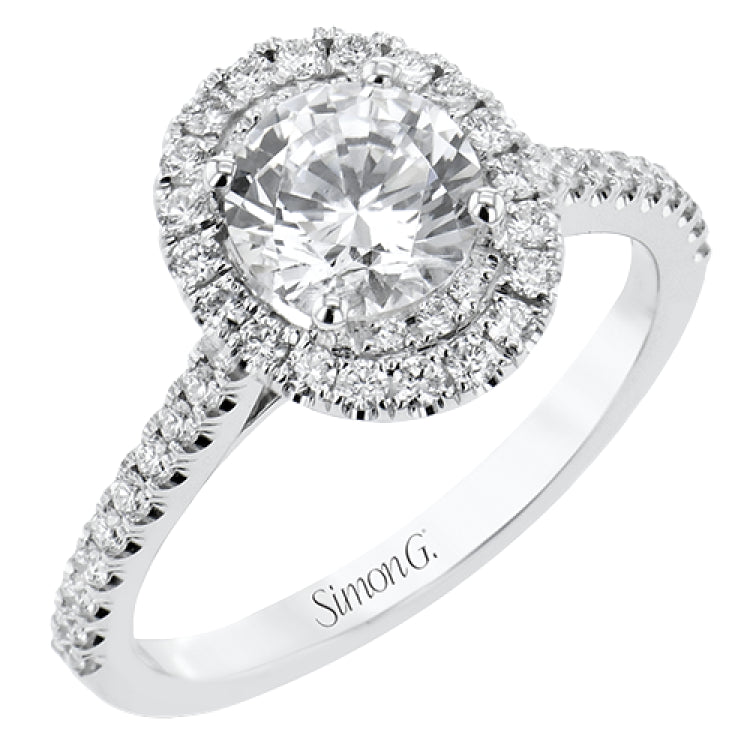 This diamond engagement ring has a sparkling line of prong set diamonds along the band, leading up to the center halo of round diamonds 0.39 ctw., and has 2 peek-a-boo yellow diamonds 0.02 ctw.