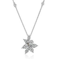 Dazzling diamonds are arranged to form this elegant floral design pendant, on a diamond station necklace 0.58 ctw.