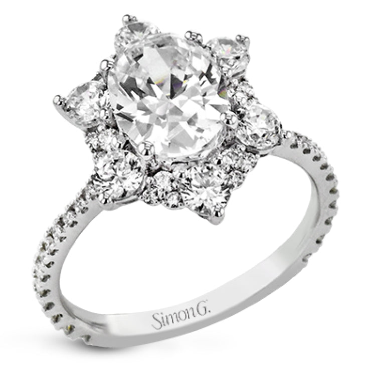 Like a crystallized explosion of light, this remarkable engagement ring design features a supernova of .60 ctw of diamonds surrounding the oval shaped center stone, as well as .38 ctw of smaller diamonds down the band.