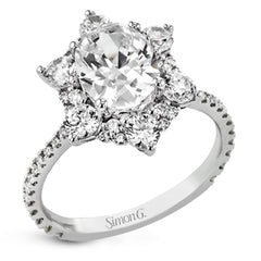 Like a crystallized explosion of light, this remarkable engagement ring design features a supernova of .60 ctw of diamonds surrounding the oval shaped center stone, as well as .38 ctw of smaller diamonds down the band.