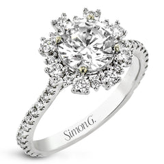 From our Super nova collection this 18K engagement ring is a unique take on the classic halo ring, and features 0.60 ctw of round diamonds