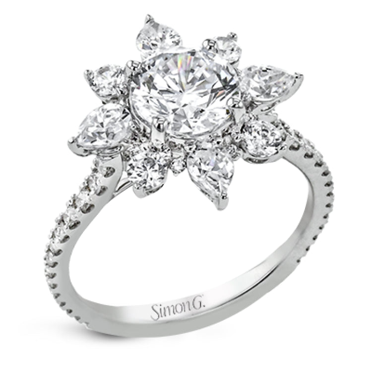 Pear shaped diamonds are set into a pointed halo that expands outward like a cosmic explosion in this Supernova Collection engagement ring.