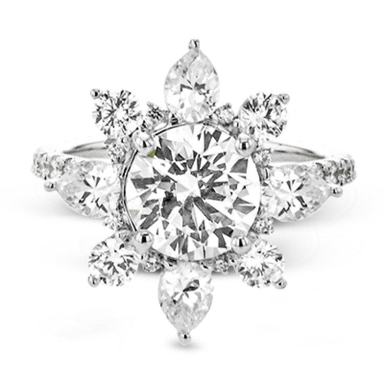 Pear shaped diamonds are set into a pointed halo that expands outward like a cosmic explosion in this Supernova Collection engagement ring.