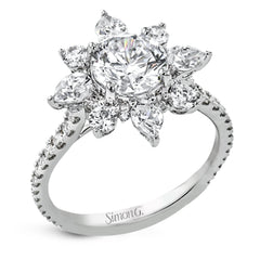 Pear shaped diamonds are set into a pointed halo that expands outward like a cosmic explosion in this Supernova Collection engagement ring.