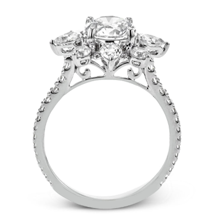 Pear shaped diamonds are set into a pointed halo that expands outward like a cosmic explosion in this Supernova Collection engagement ring.