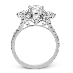Pear shaped diamonds are set into a pointed halo that expands outward like a cosmic explosion in this Supernova Collection engagement ring.