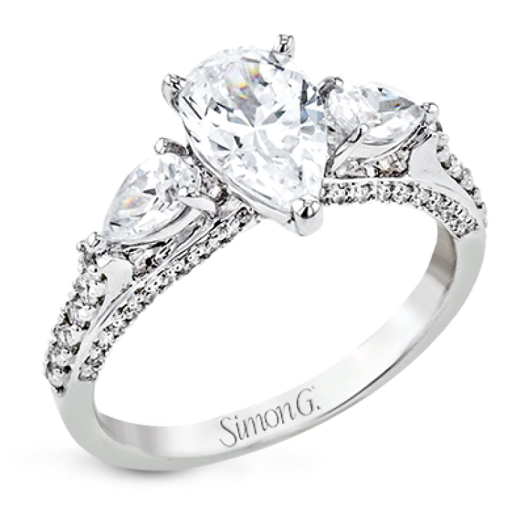 Pear shaped side stone set horizontally give this 18k white gold engagement ring a modern feel, accentuating the pear shape center stone.