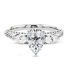 Pear shaped side stone set horizontally give this 18k white gold engagement ring a modern feel, accentuating the pear shape center stone.