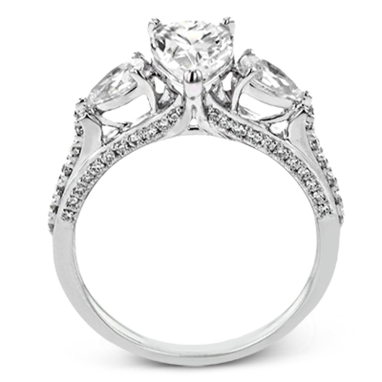 Pear shaped side stone set horizontally give this 18k white gold engagement ring a modern feel, accentuating the pear shape center stone.