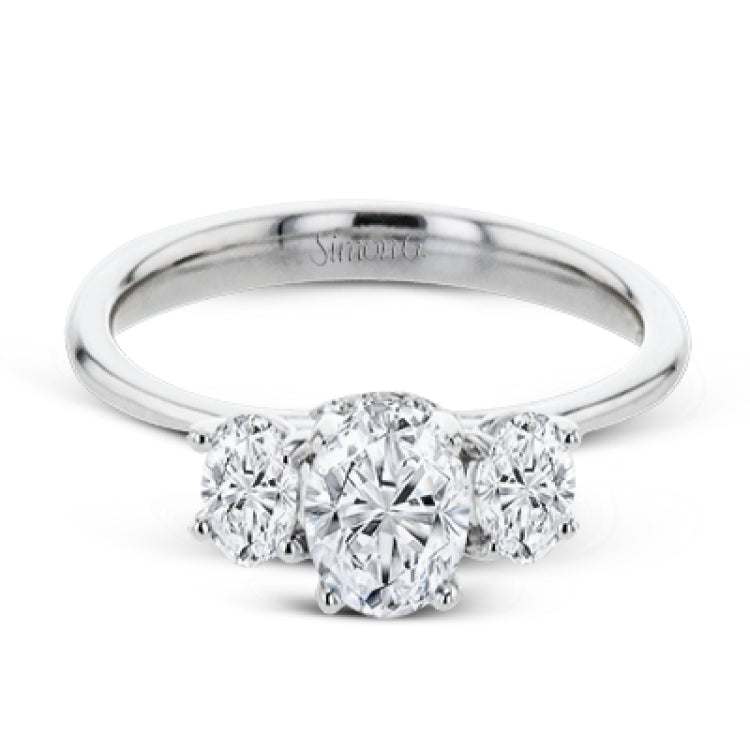 This 18k white gold engagement ring is a updated take on a classic three stone design, this time rendered with three sparkling oval shaped diamonds.