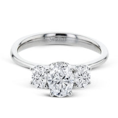 This 18k white gold engagement ring is a updated take on a classic three stone design, this time rendered with three sparkling oval shaped diamonds.