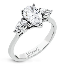 This distinctive three stone ring is new take on a classic style, with .45 ctw of pear shaped side diamonds highlighting the pear shaped center stone.