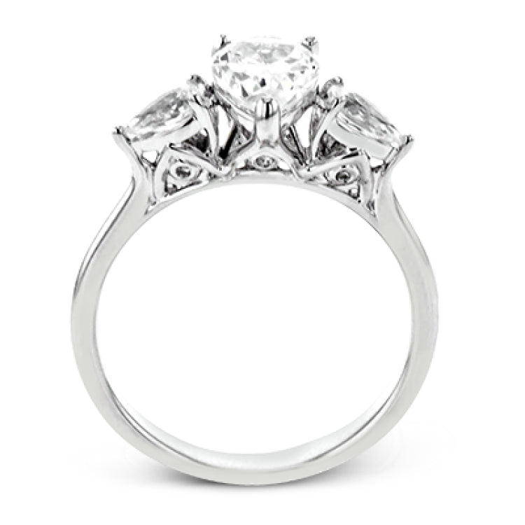 This distinctive three stone ring is new take on a classic style, with .45 ctw of pear shaped side diamonds highlighting the pear shaped center stone.