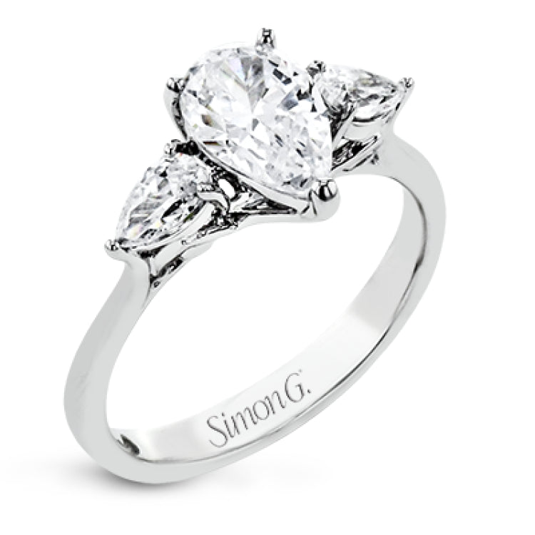This distinctive three stone ring is new take on a classic style, with .45 ctw of pear shaped side diamonds highlighting the pear shaped center stone.