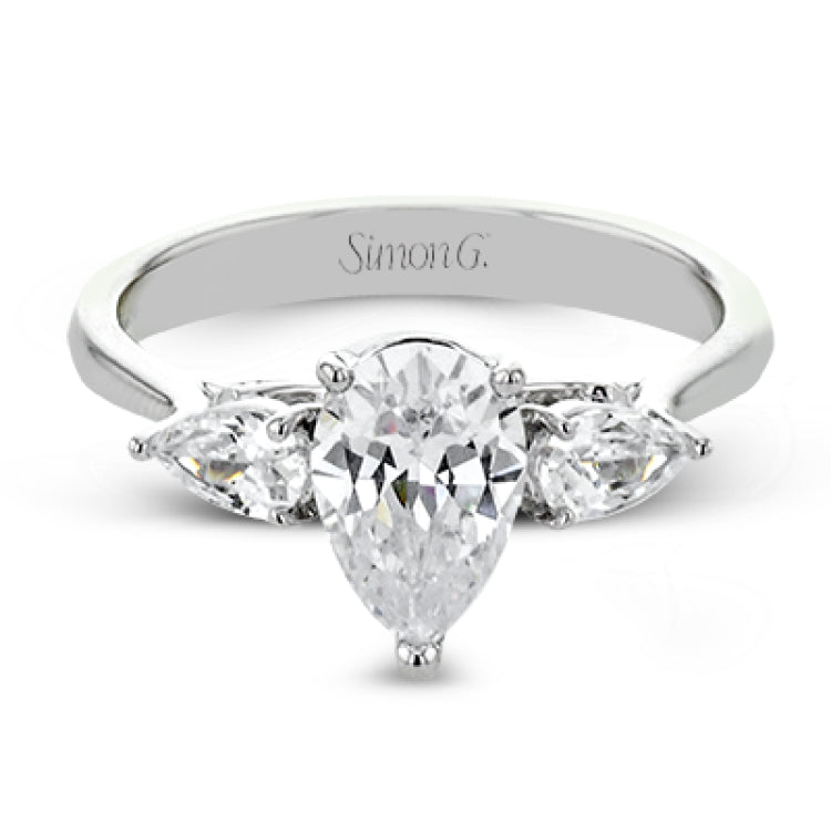 This distinctive three stone ring is new take on a classic style, with .45 ctw of pear shaped side diamonds highlighting the pear shaped center stone.