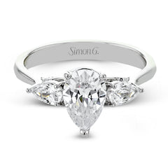 This distinctive three stone ring is new take on a classic style, with .45 ctw of pear shaped side diamonds highlighting the pear shaped center stone.