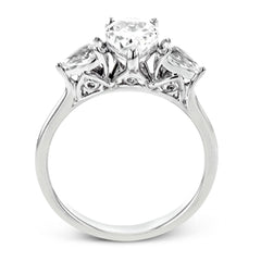 This distinctive three stone ring is new take on a classic style, with .45 ctw of pear shaped side diamonds highlighting the pear shaped center stone.
