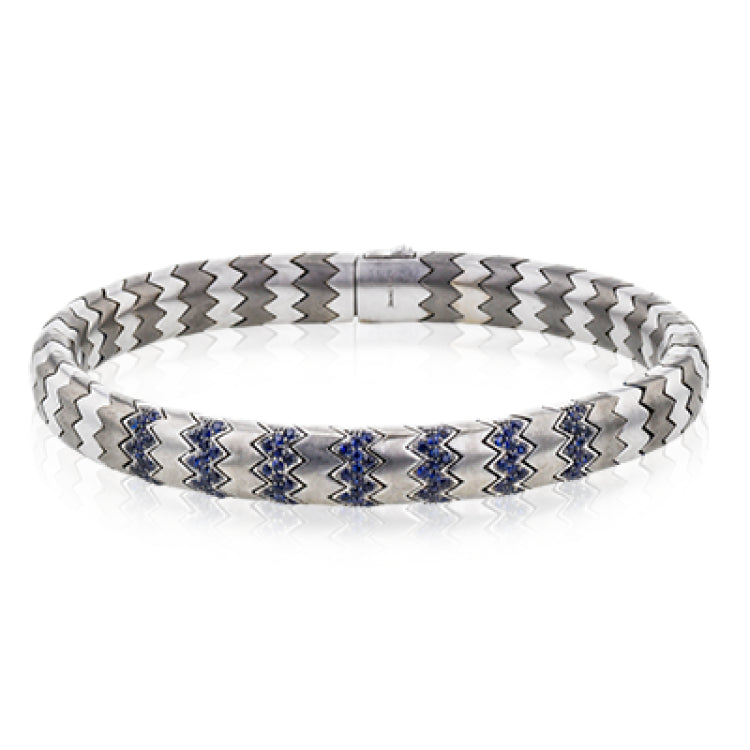 This men's bracelet in white gold and titanium zig zag pattern is accented by the perfect touch of 1.04 ctw of blue sapphires.