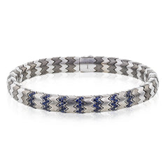 This men's bracelet in white gold and titanium zig zag pattern is accented by the perfect touch of 1.04 ctw of blue sapphires.