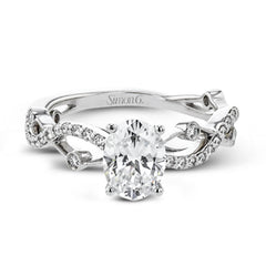 The intertwined design of this 18k gold engagement ring perfectly offsets an oval shaped center stone.