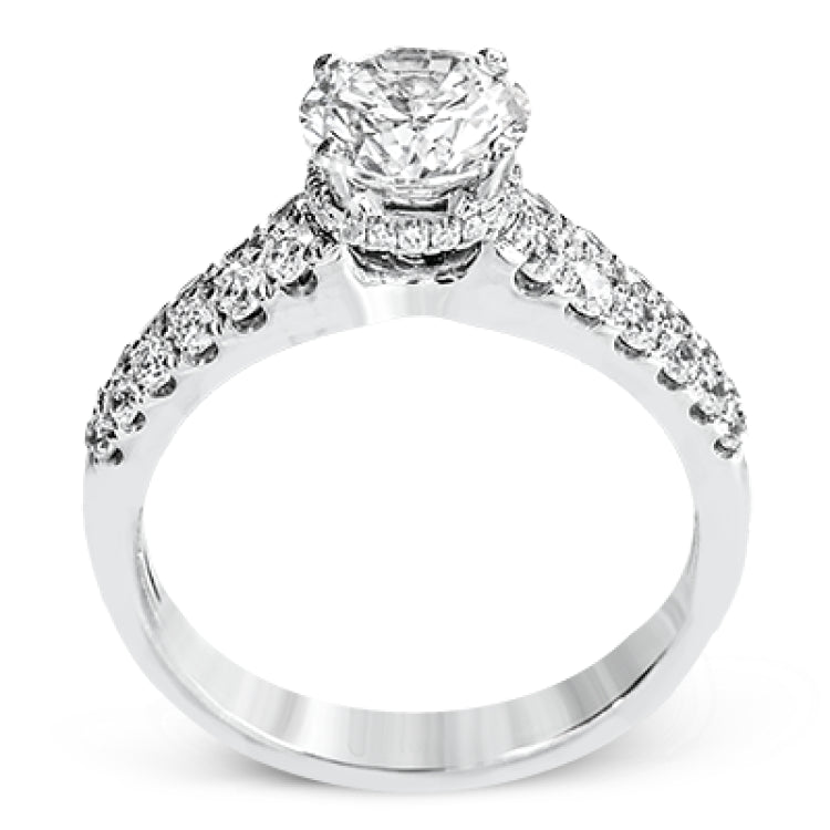 Shining white diamonds encircle the center stone in this Underhalo engagement ring, while also extending across the sides of the ring to ensure it glitters from all directions.
