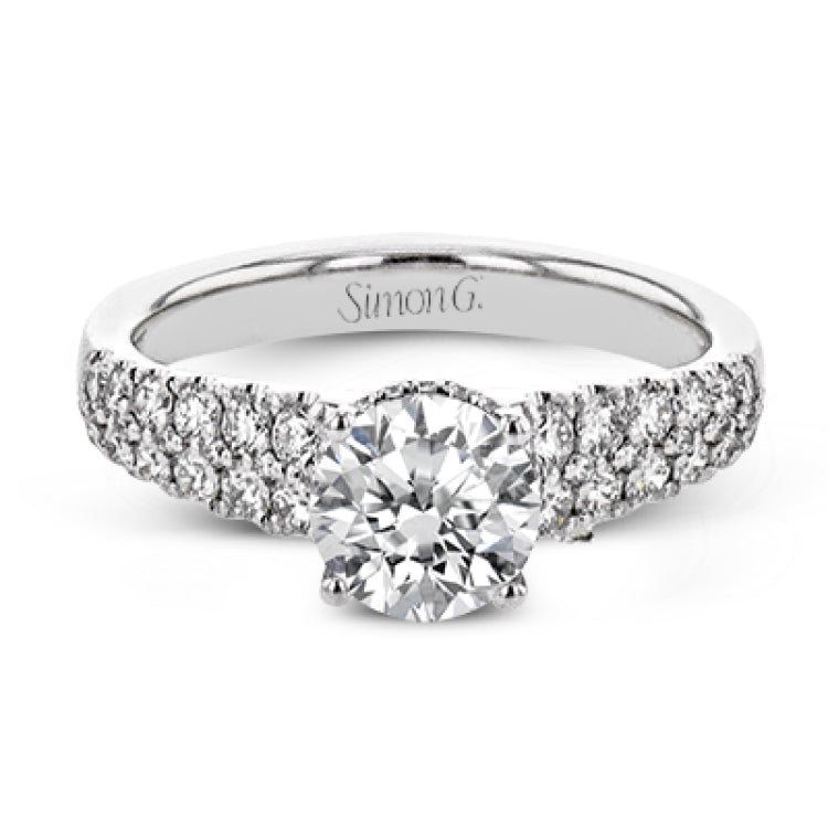 Shining white diamonds encircle the center stone in this Underhalo engagement ring, while also extending across the sides of the ring to ensure it glitters from all directions.