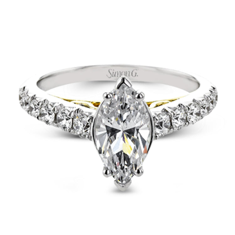 A touch of 18k yellow gold filigree on the interior of this ring adds a special touch to this 18k white gold engagement ring made for a marquise shape center stone.