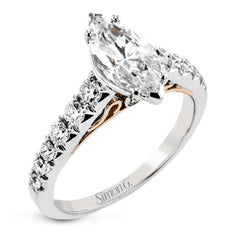 A touch of 18k yellow gold filigree on the interior of this ring adds a special touch to this 18k white gold engagement ring made for a marquise shape center stone.