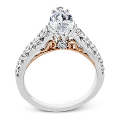A touch of 18k yellow gold filigree on the interior of this ring adds a special touch to this 18k white gold engagement ring made for a marquise shape center stone.