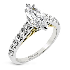 A touch of 18k yellow gold filigree on the interior of this ring adds a special touch to this 18k white gold engagement ring made for a marquise shape center stone.