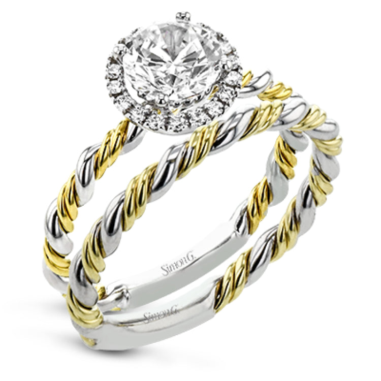 This ring is a twist on a halo engagement ring, with 18k yellow and white gold intertwining in the band.