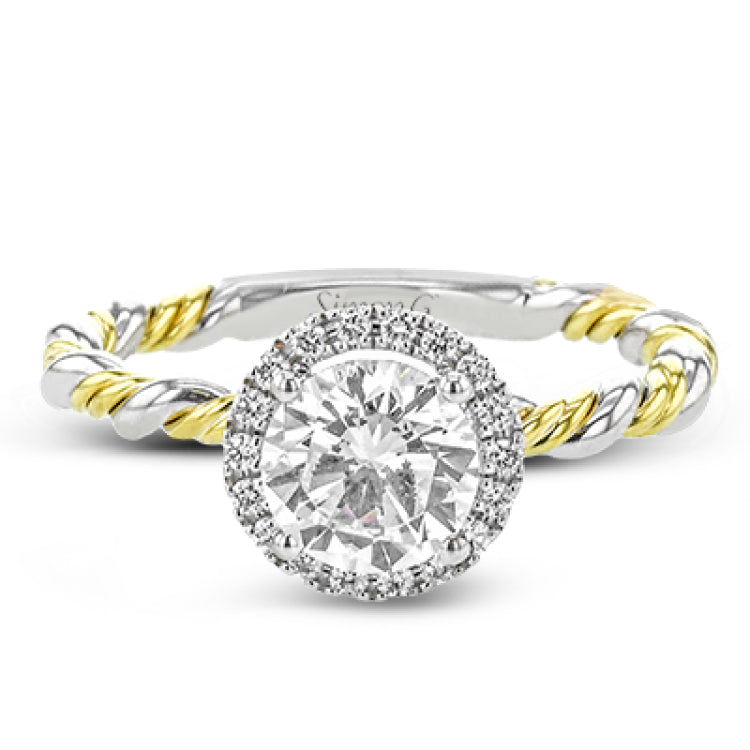 This ring is a twist on a halo engagement ring, with 18k yellow and white gold intertwining in the band.